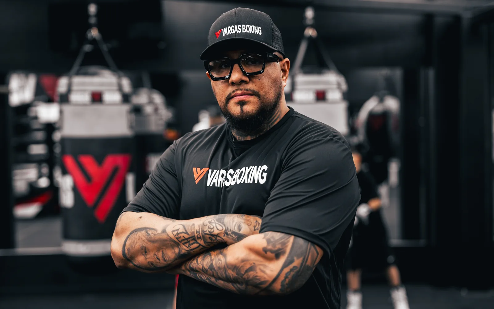 Fernando Vargas posing with arms crossed inside the Vargas Boxing gym.